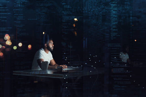 Coding late into the night Shot of a programmer working on a computer code at night digital code stock pictures, royalty-free photos & images