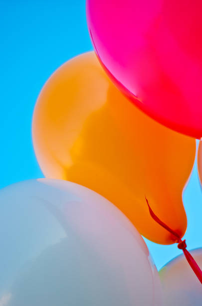 istock many colorful balloons launched  in the blue sky 1055057334