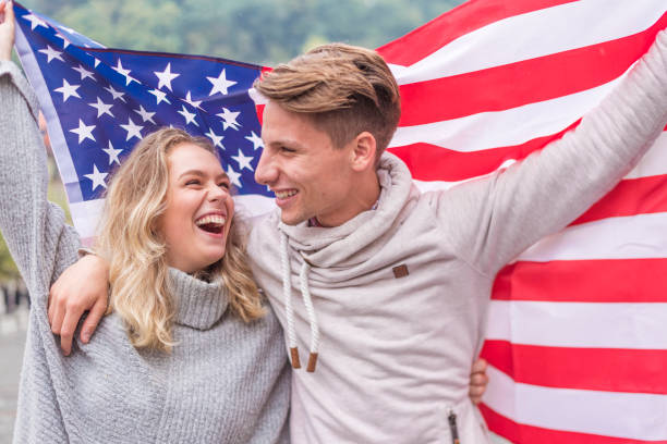 istock Happy young couple holding American flag 1055059040