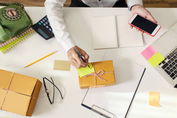 istock Man using smartphone. Delivery and receiving orders from customers online. 1055059624