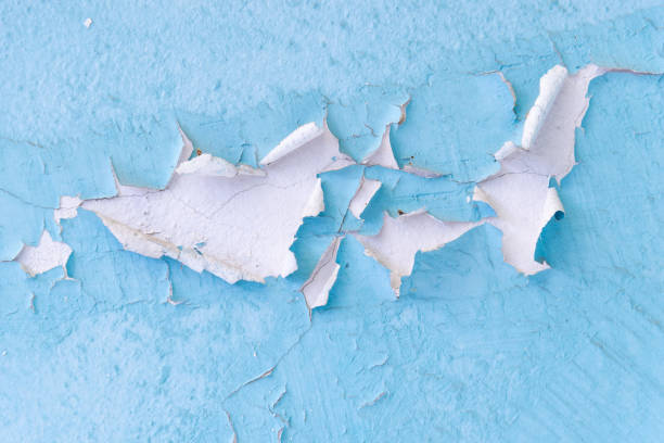 istock Peeling paint and wall cracks - close up view 1055060136