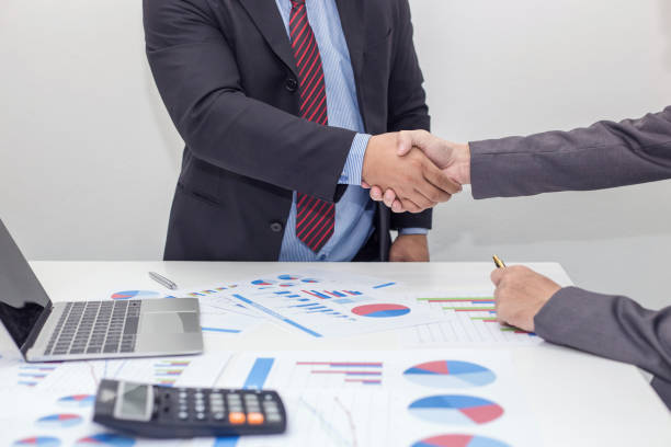 istock Business shaking hands. Business executives shaking hands to congratulate the joint. 1055060218