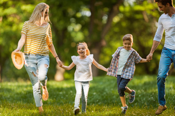 istock Carefree family having fun while running in the park. 1055062950