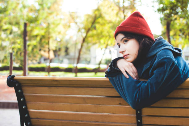 lonely beautiful woman is sitting on the bench