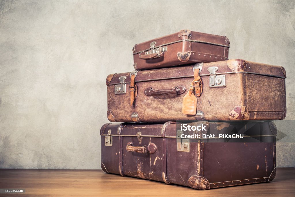 Vintage old classic travel leather suitcases circa 1940s. Travel luggage concept. Retro instagram style filtered photo Suitcase Stock Photo