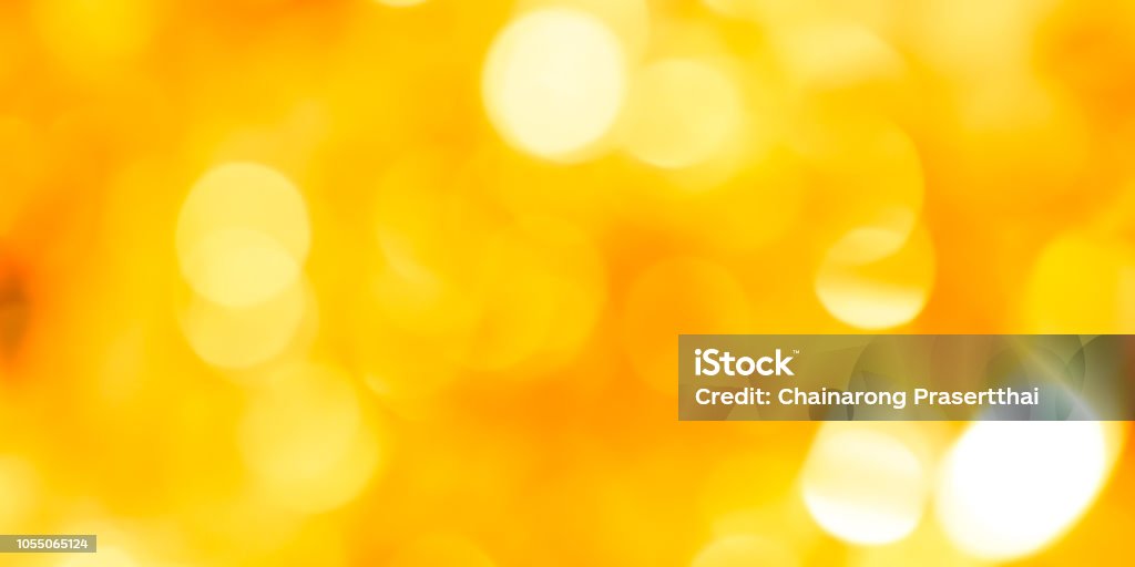 abstract blur glowing yellow color panoramic background with double exposure bokeh light for happy new year and merry christmas celebration festival design element concept Yellow Background Stock Photo