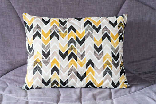 Colorful cushion on the couch.