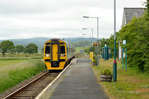 Railway diesel train locomotive at rural Talsarnau station, Gwynedd in North Wales UK.