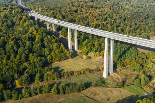 istock Highway bridge through forestland - aerial view 1055071374