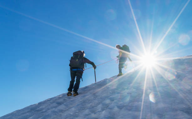 Climbers on a snowy slope. Italy. Courmayeur. Mont Blanc Massif. Climbers on a snowy slope in the Mont Blanc Region upward mobility stock pictures, royalty-free photos & images