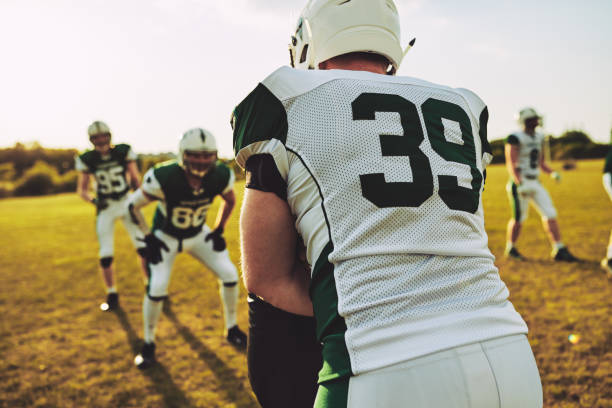 istock American football team doing tackle drills during practice 1055081830
