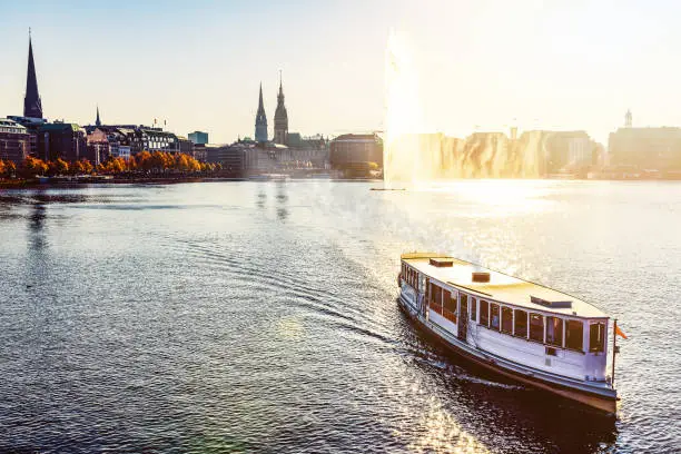 historic steam boat on Alster Lake in Hamburg, Germany in golden sunlight