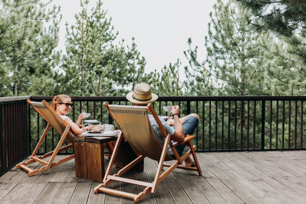 istock Couple enjoying coffee on a balcony in the mountains 1055084354