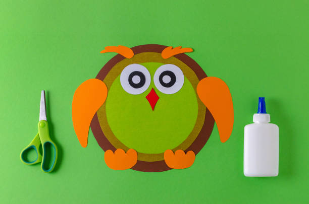 istock making a owl with color paper, glue and scissors 1055088606
