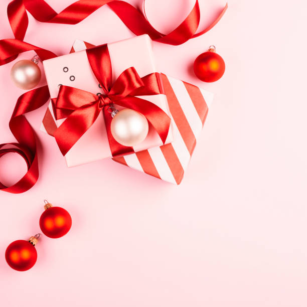istock Christmas gifts on pink background. 1055091024