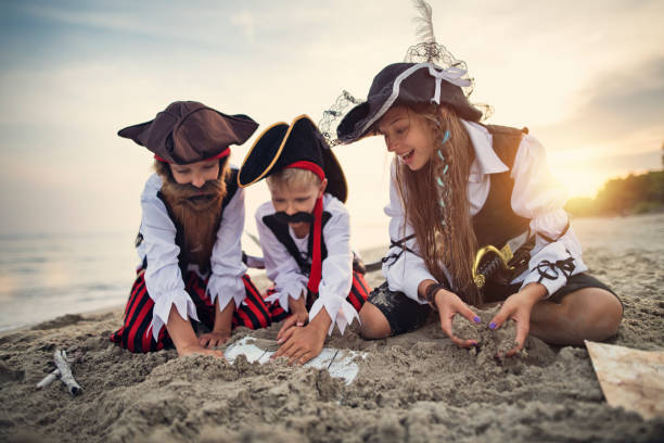 istock Kids pirates digging up treasure chest 1055091142