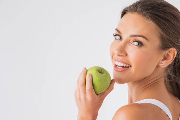 istock Woman holding green apple 1055091614
