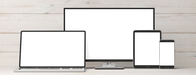 Set of realistic blank monitors, responsive design. Computer monitor, laptop, tablet and smartphone on wooden background, copy space. 3d illustration