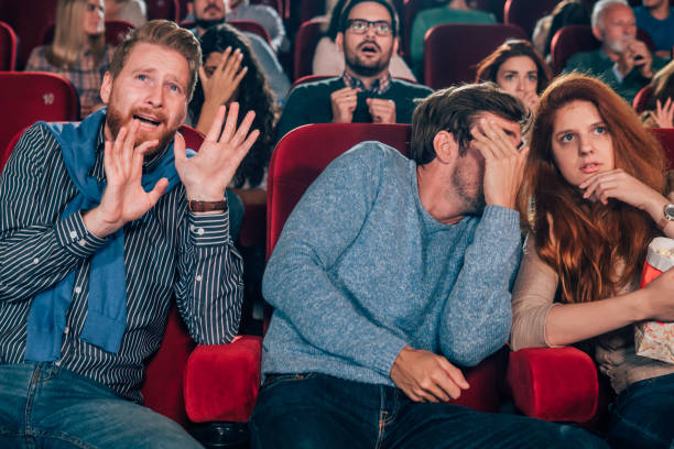 istock Young people watching a movie in fear 1055093862