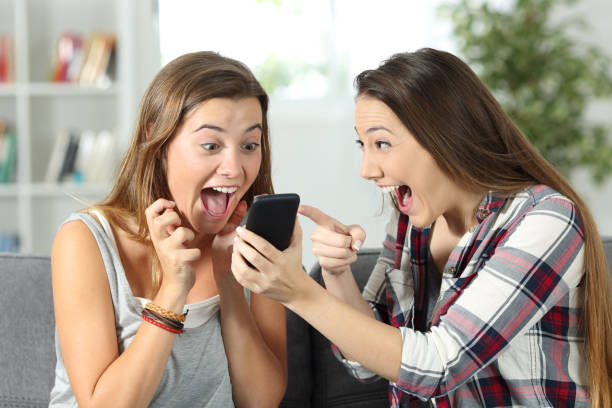 istock Excited friends watching online amazing content 1055094664