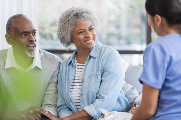 istock Senior couple visit with a caring nurse 1055095214
