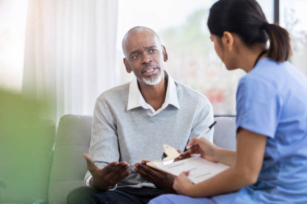 istock Concerned senior adult asks question during medical appointment 1055095216