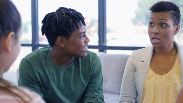 istock Teenage boy surprises mother in group therapy 1055095310