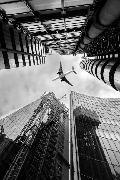 istock Airplane flying above skyscrapers 1055097660