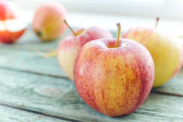 istock Red apples on turquoise wooden background. Autumn days. 1055098552