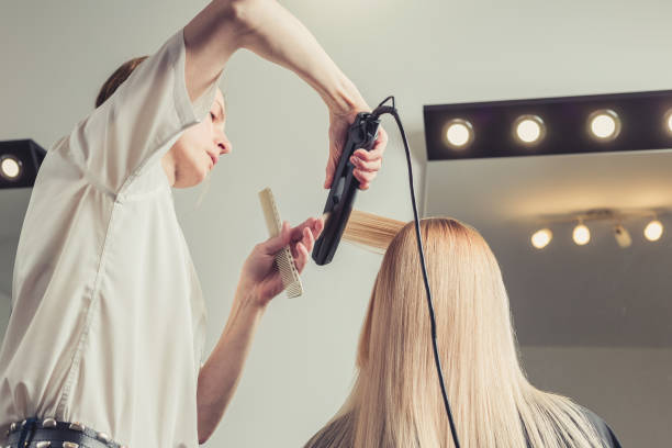 istock Hairdresser making a hairstyle for client 1055099072