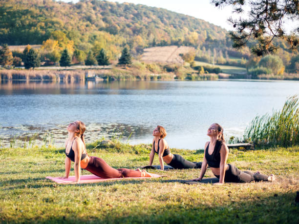 istock Women doing yoga on the lake 1055099202