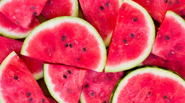 istock Fresh sliced watermelon wooden background 1055102992