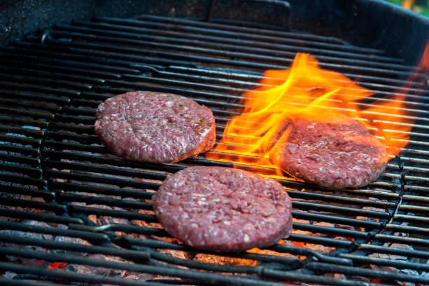 istock Hamburgers are cooking on the grill 1055104436