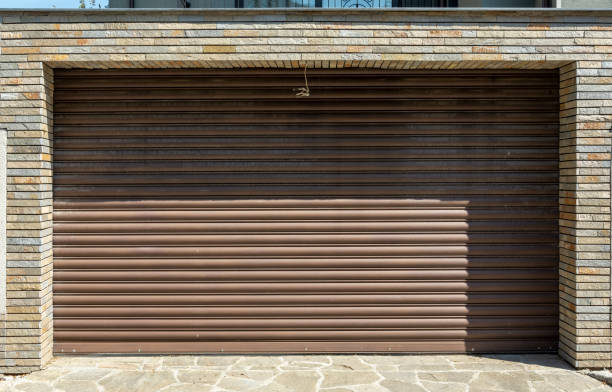 istock Iron garage door with stone bricks on the side.big shadow. 1055104846