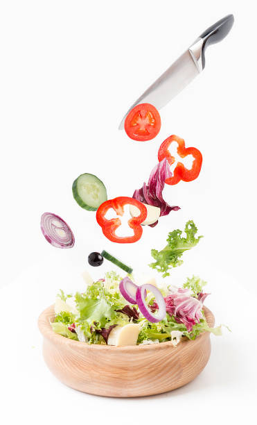 istock Wooden dishes with salad on a white background. 1055104988