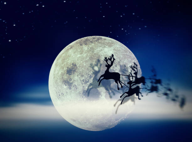 istock Santa Claus Sleight and Reindeers Silhouette Flying over the Moon 1055105792