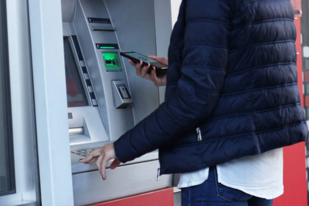 istock Cash Bankomat with Smartphone 1055108732