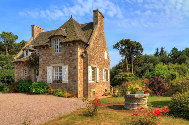 Beautiful view of a traditional French country house in Brittany, France, in summer with a blue sky