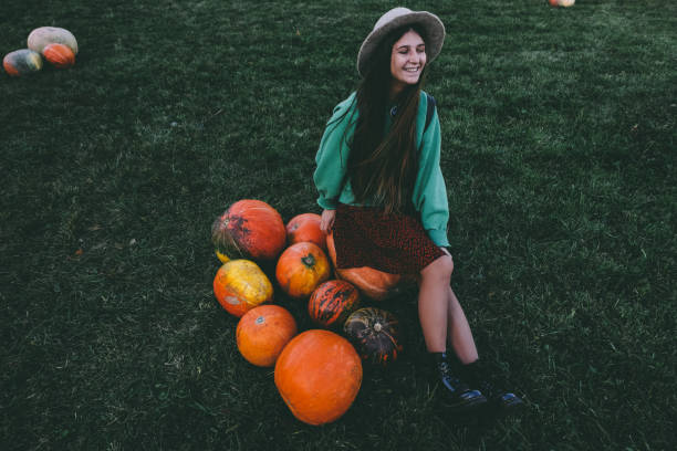 istock Beautiful woman in hat with pumpkin 1055110506