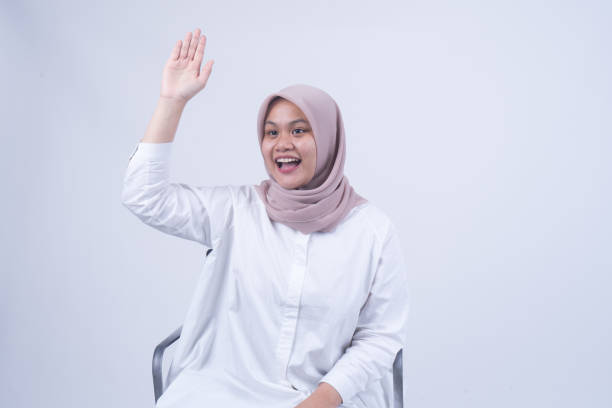 istock Asking Question From Muslim Asian Women Student - Isolated 1055112564