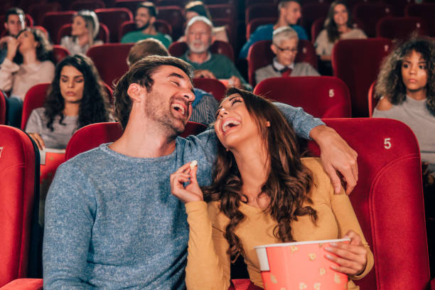 istock Laughing couple hugging at cinema 1055116110