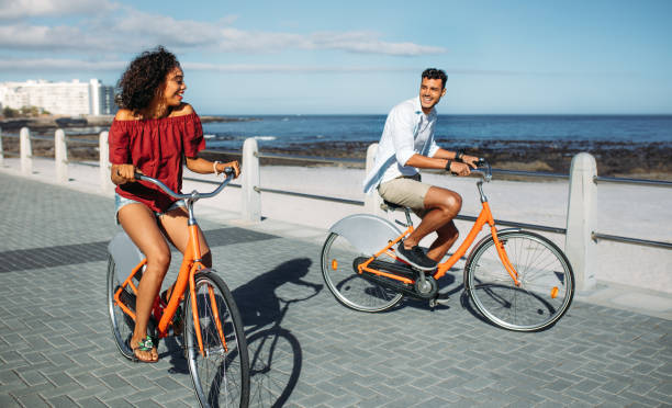 istock Couple riding bicycles in street 1055117290