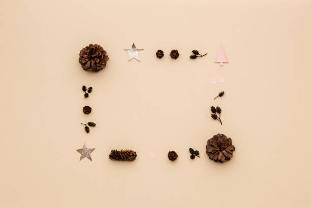 istock Christmas still life border. Xmas objects frame over beige background. 1055119248