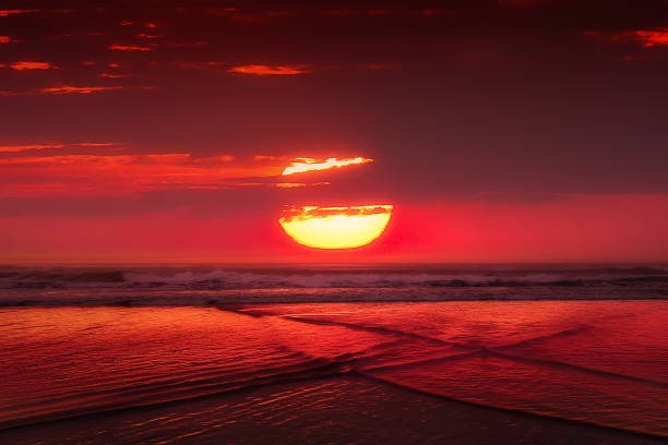 istock red sunset with big sun over the sea 1055120764