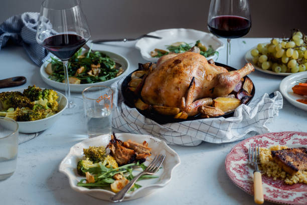 istock Big festive dinner with roasted chicken, wine and various garnishing. Celebration concept 1055129114
