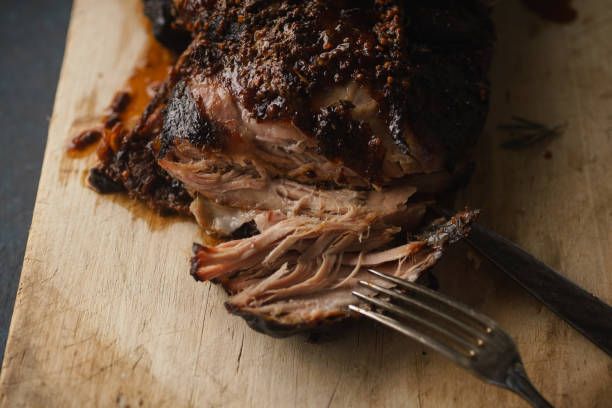 Slow-cooked pork with sugar glazing. Close up view with vintage fork