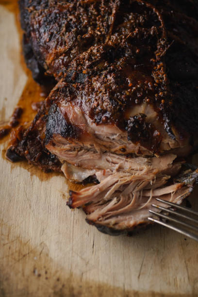 istock Slow-cooked pork with sugar glazing. Close up view with vintage fork 1055130264