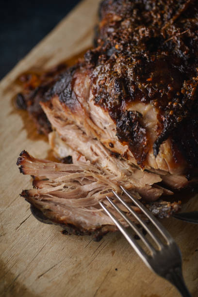 istock Slow-cooked pork with sugar glazing. Close up view with vintage fork 1055130310