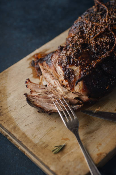 istock Slow-cooked pork with sugar glazing. Close up view with vintage fork 1055130356