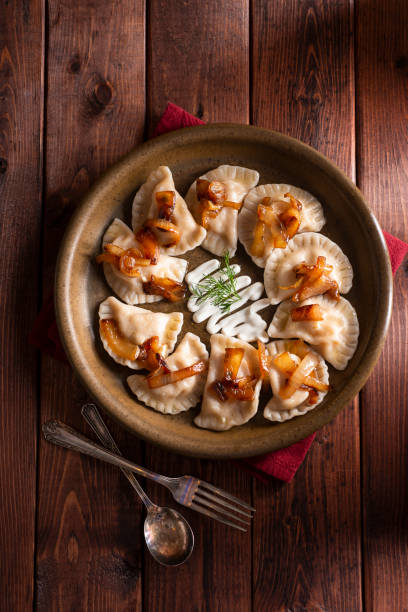 Dumplings Pierogi Plate with Sour Cream polish culture photos stock pictures, royalty-free photos & images
